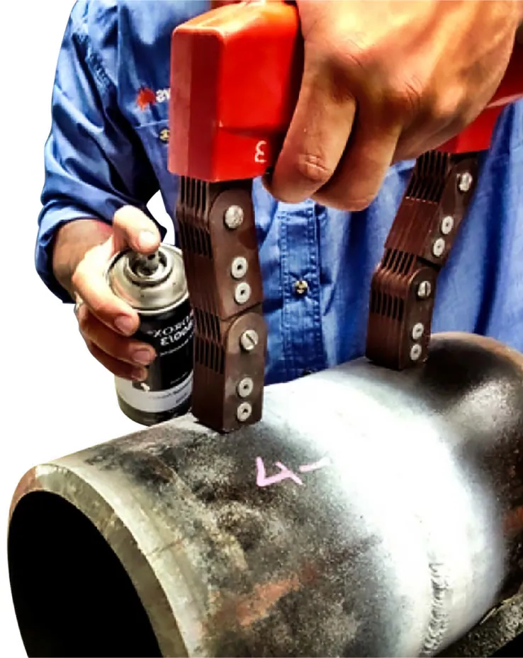 Technician evaluating magnetic particle indications